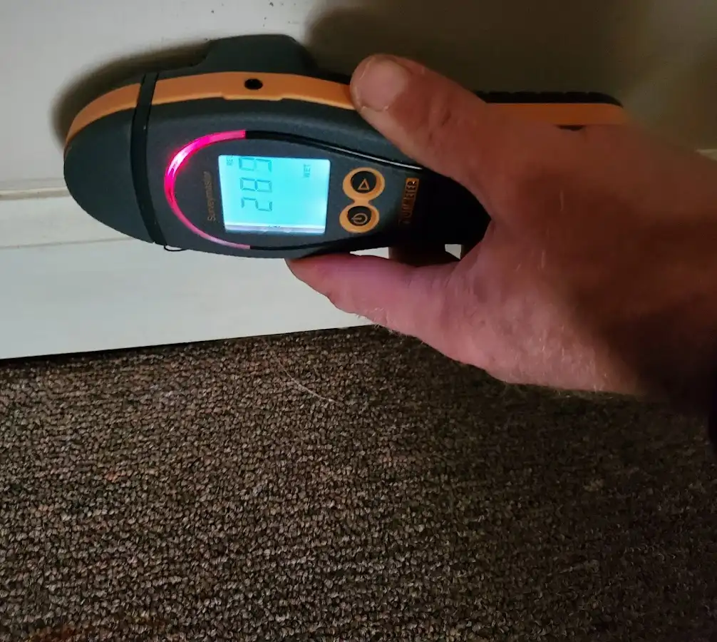 Moisture detection at baseboard during Storm Damage Restoration in Haiku-Pauwela